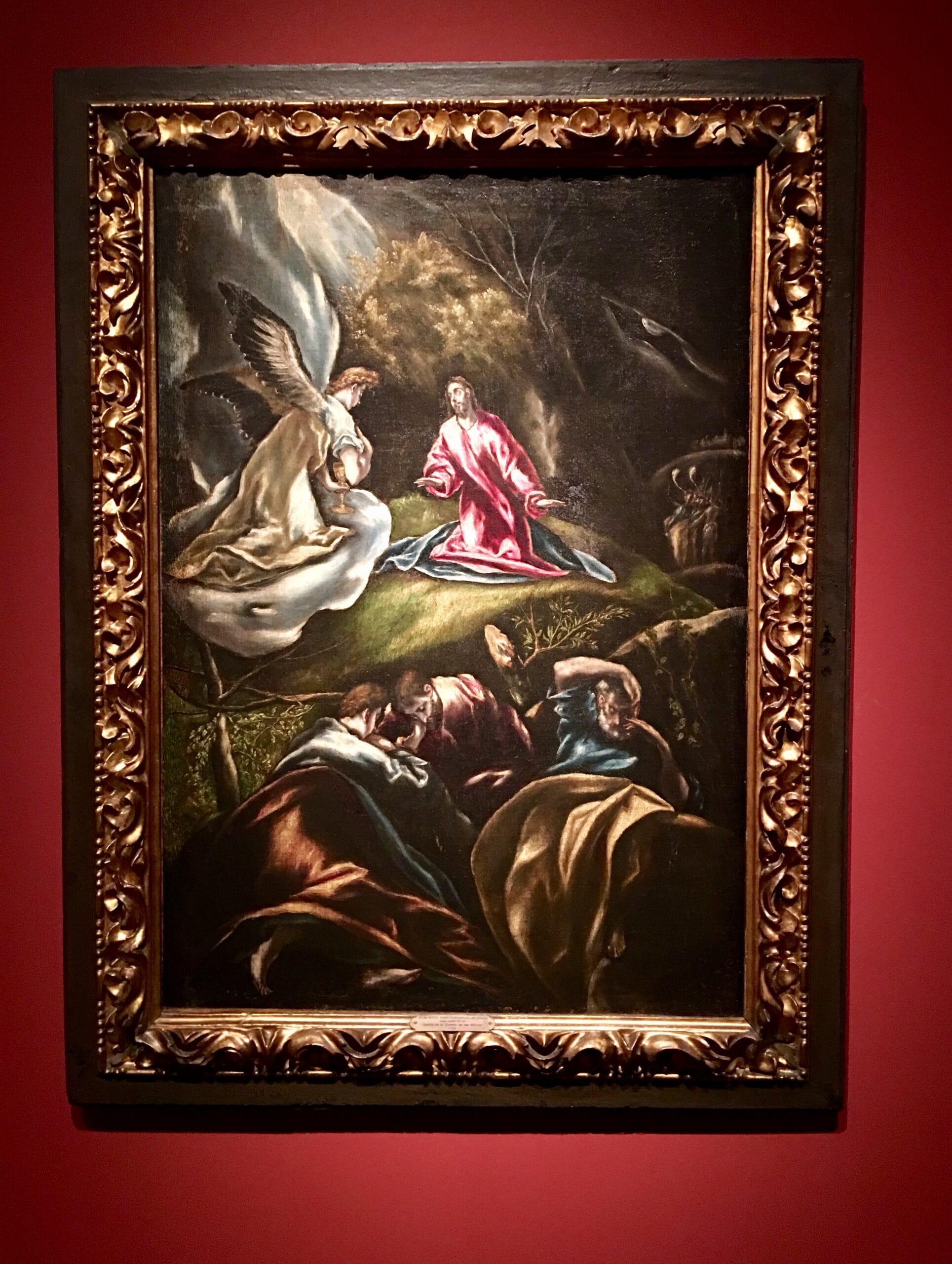 El Greco’s Agony in the Garden: Christ kneels on dark rocks while an angel offers a chalice and the apostles sleep under a stormy sky.